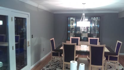 Dining room with gray walls, white trim, and clean painted finish
