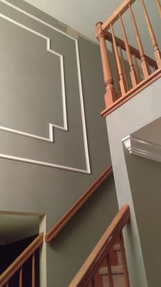 Staircase wall with decorative molding and painted finish